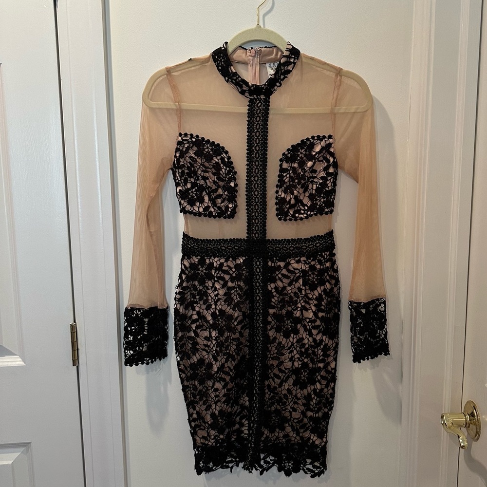Sheer long sleeve mini dress with black crochet detailing. Fits sizing XS or S